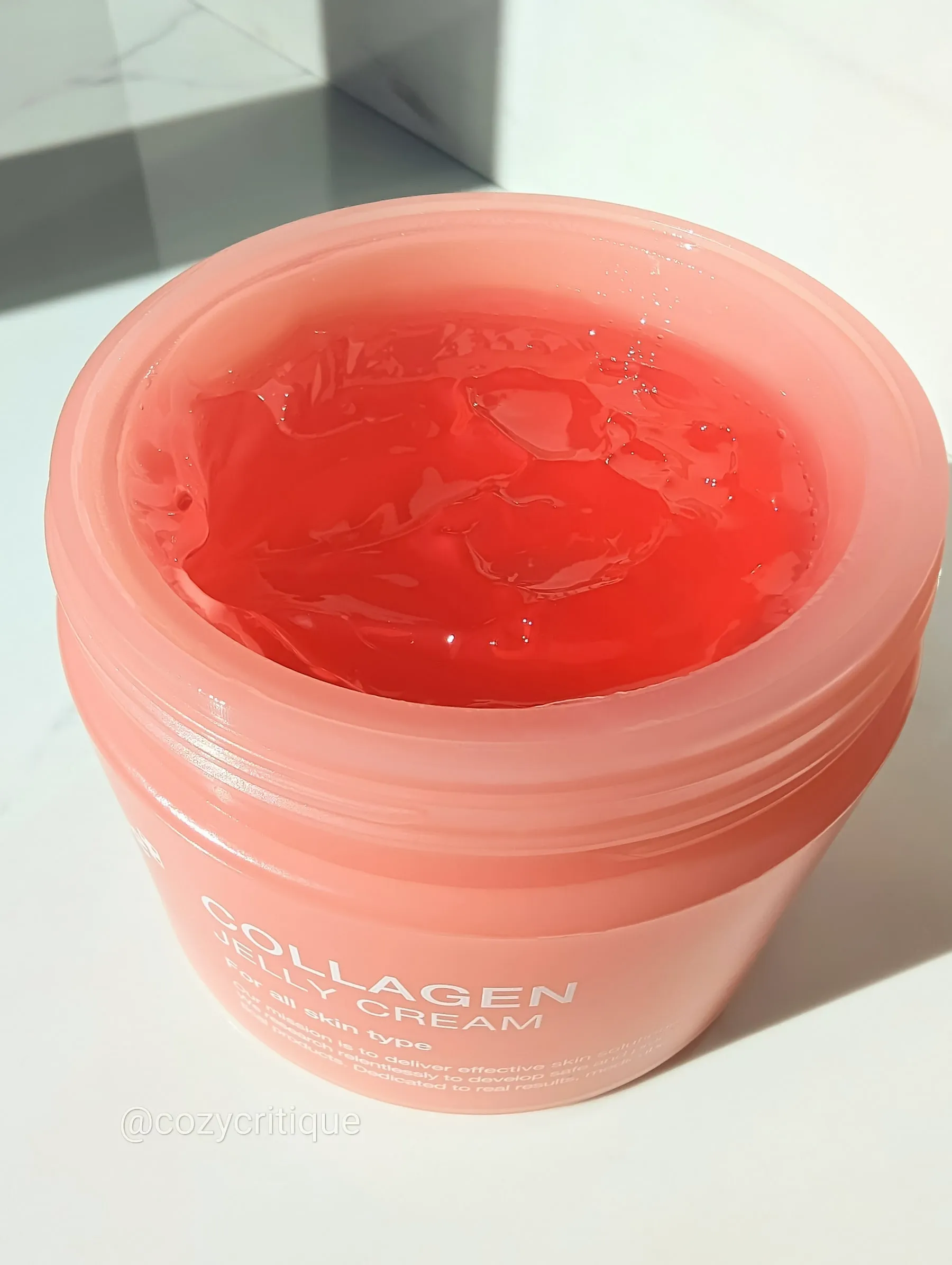 a closeup shot of a jaw of cream with the lid off.