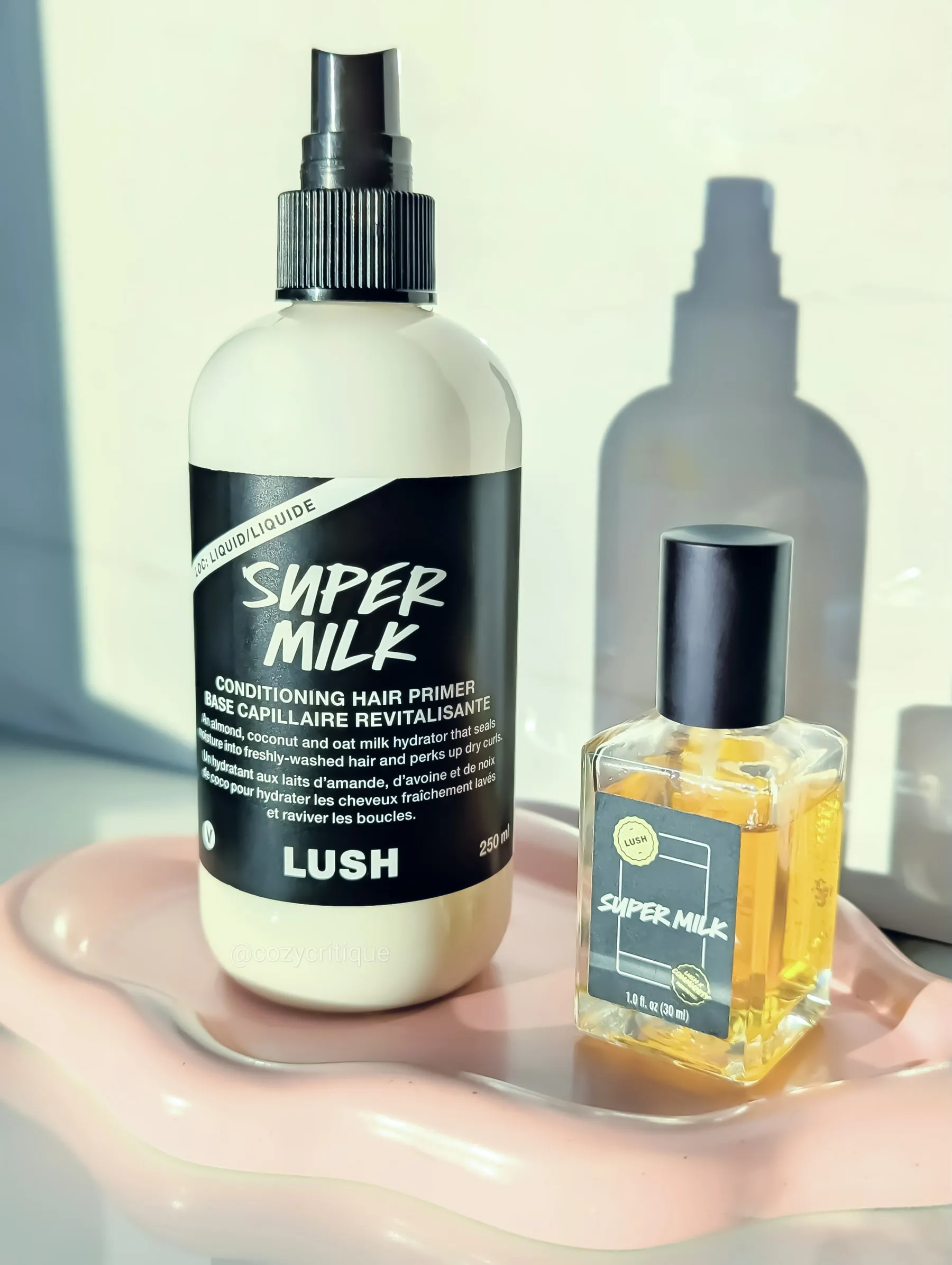 Lush Super Milk hair primer and Super Milk perfume standing on a tray