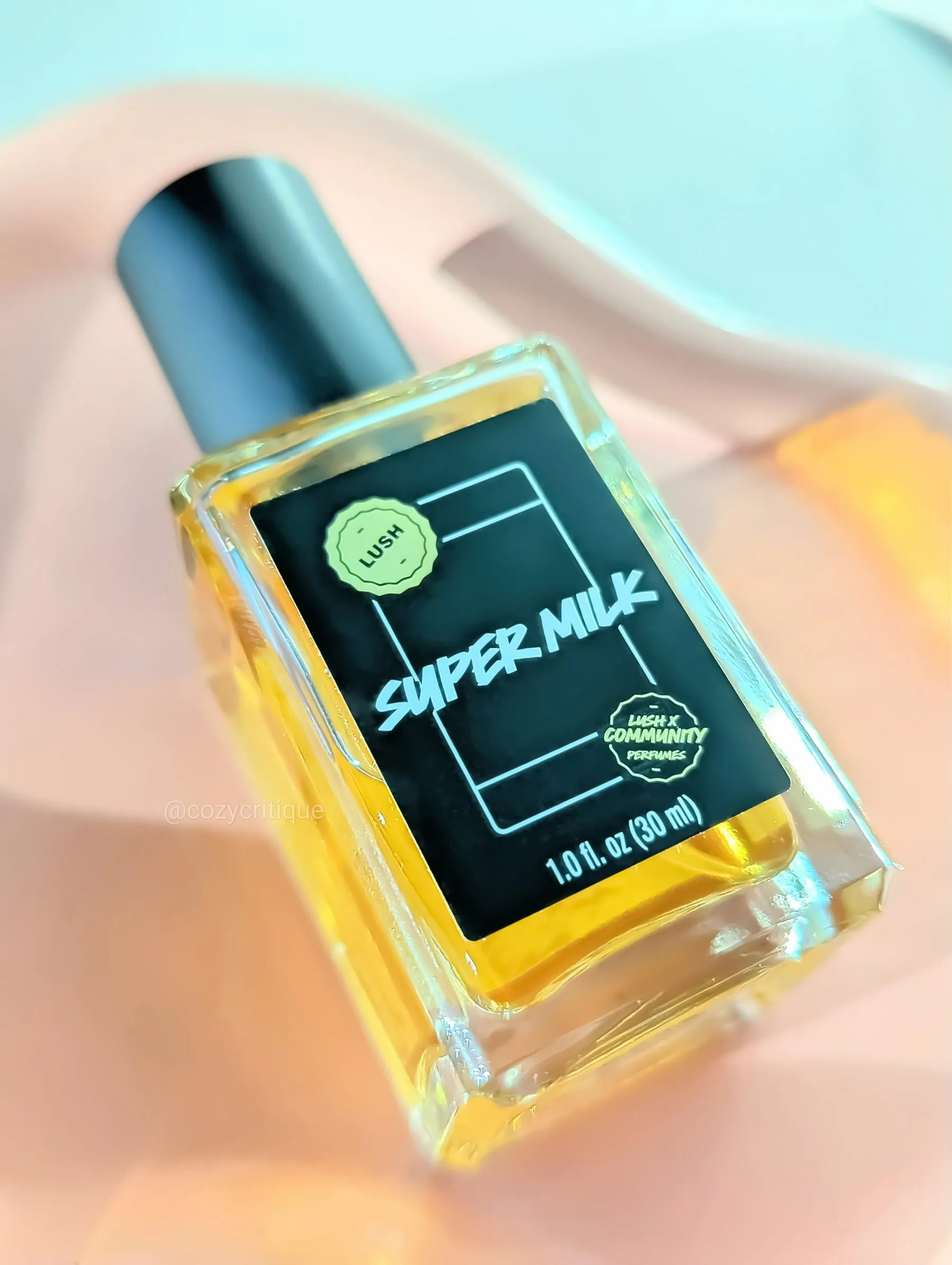 A bottle of Lush Super Milk perfume laying on a tray
