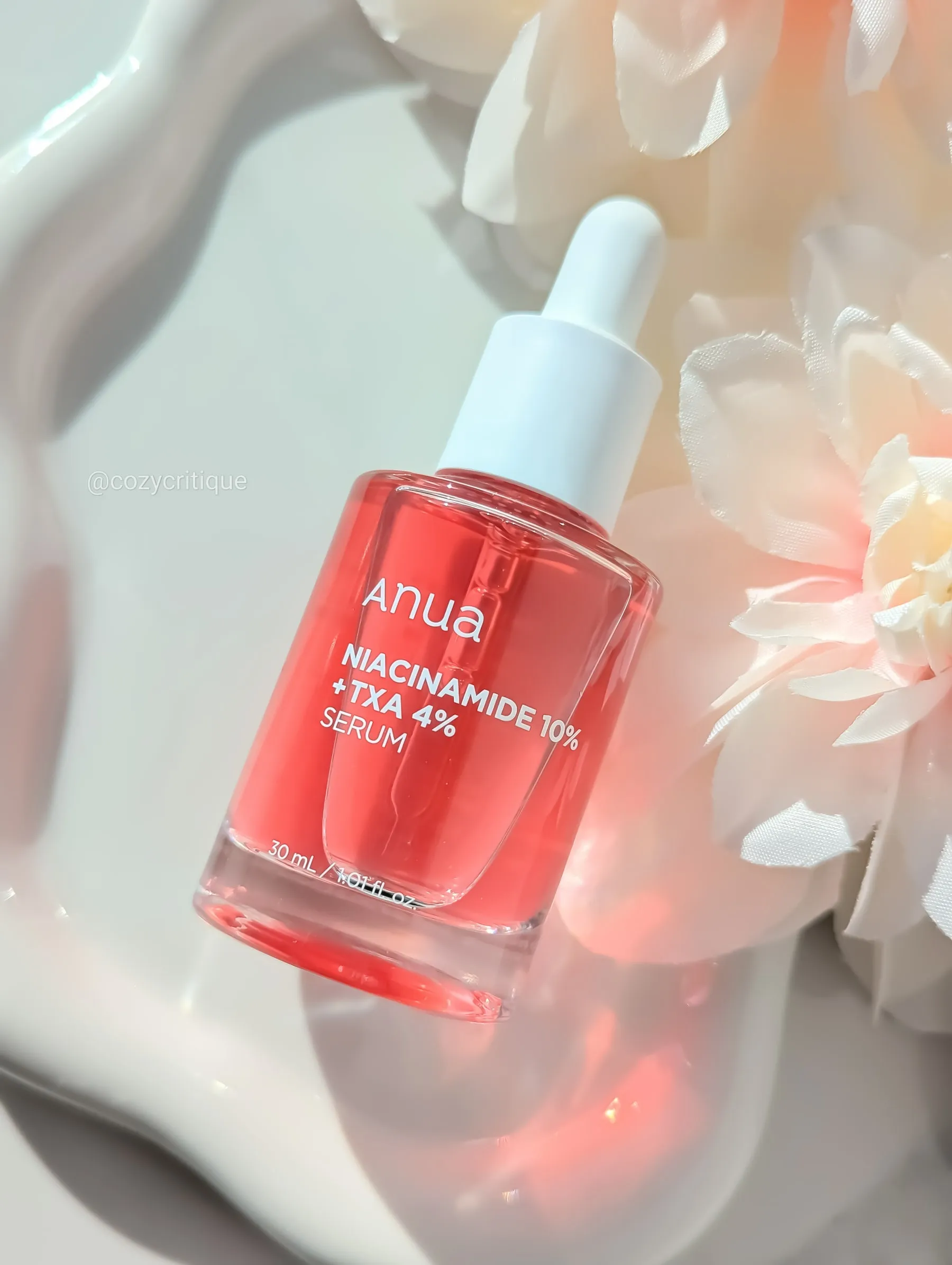 Anua Niacinamide + TXA serum laying on a tray