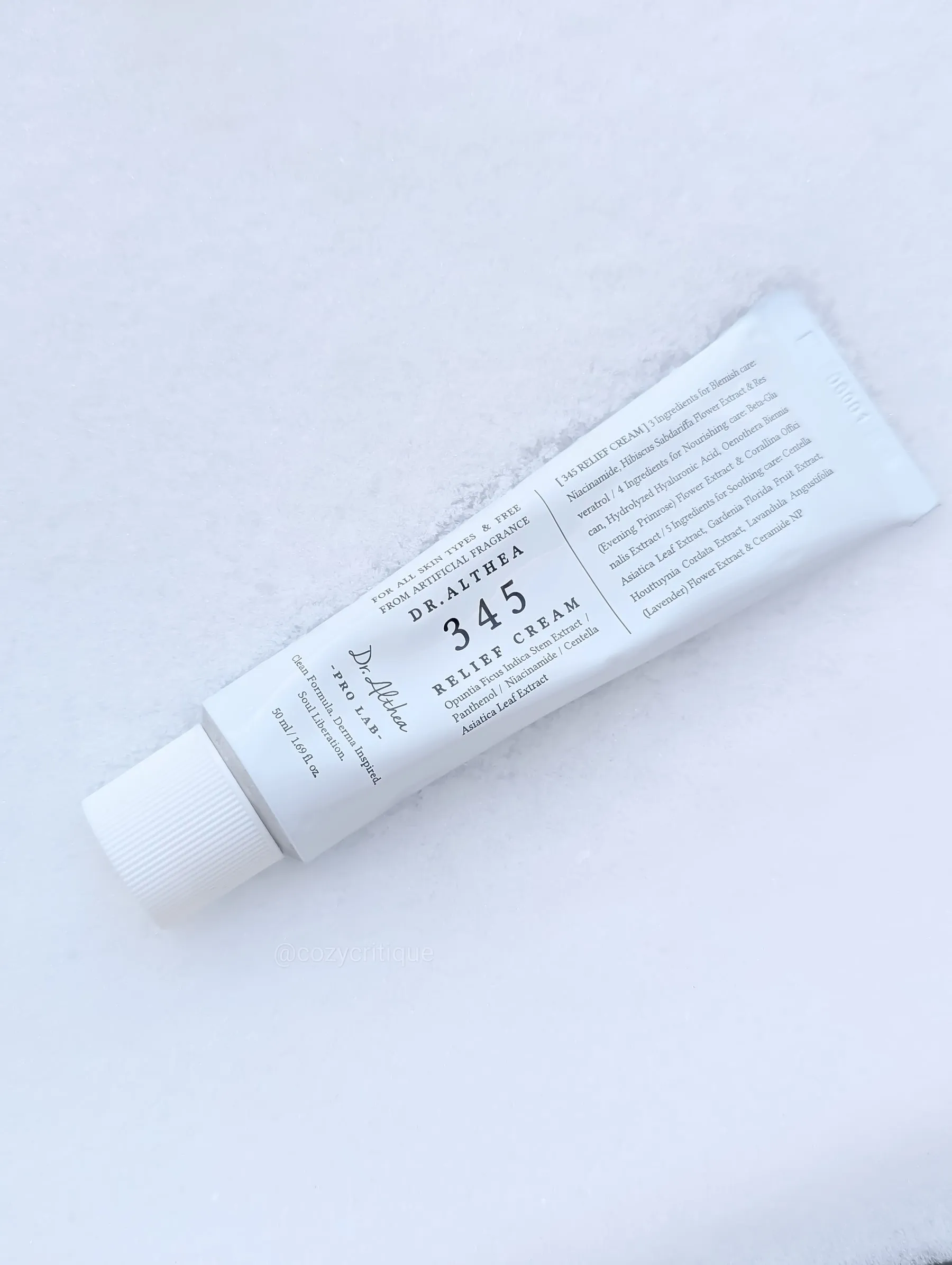 A white tube of Dr. Althea 345 Relief Cream on snow. Text includes "for all skin types" and "50ml." Calm and soothing ambiance.
